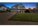 Stunning two-story home with a three-car garage and manicured front lawn under twilight sky at 541 Lombard St, Marietta, GA 30064