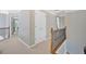 Carpeted hallway with decorative wrought iron railing and white closet doors at 541 Lombard St, Marietta, GA 30064