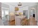 Bright kitchen with island seating, stainless appliances, custom hood, and hardwood flooring at 541 Lombard St, Marietta, GA 30064