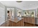 Open-concept kitchen featuring a central island, wood cabinetry, and seamless transition to the living area at 541 Lombard St, Marietta, GA 30064