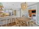 Open-concept kitchen flows into a dining area, with barstool seating and stone countertops at 541 Lombard St, Marietta, GA 30064