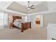 Spacious main bedroom with tray ceiling, carpet, and en suite bathroom access at 541 Lombard St, Marietta, GA 30064