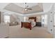 Bright main bedroom with neutral tones, tray ceiling, and a sitting area at 541 Lombard St, Marietta, GA 30064