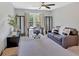 Home office featuring a ceiling fan, dark-wood leather sofa, and large bright window at 541 Lombard St, Marietta, GA 30064