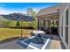 Outdoor patio area with a dining table, leading to a screened-in porch, overlooking the landscaped yard at 541 Lombard St, Marietta, GA 30064