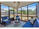 Cozy sunroom with brick flooring, comfortable seating, and scenic backyard views at 541 Lombard St, Marietta, GA 30064