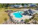 Aerial view of a community pool surrounded by lounge chairs and a playground at 802 Milo Bay St, Loganville, GA 30052