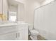 Clean and bright bathroom with a large mirror, a white vanity, and a shower-tub combination at 802 Milo Bay St, Loganville, GA 30052