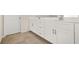 Modern bathroom vanity with double sinks, white cabinets, and tile flooring at 802 Milo Bay St, Loganville, GA 30052