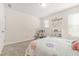 Comfortable bedroom with plush carpeting, natural light, and feminine decor at 802 Milo Bay St, Loganville, GA 30052