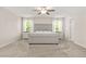 Spacious bedroom featuring plush carpeting, a ceiling fan, and large windows with bright natural light at 802 Milo Bay St, Loganville, GA 30052