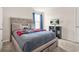 Comfortable bedroom featuring a large bed with storage underneath and natural light at 802 Milo Bay St, Loganville, GA 30052