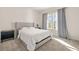 Comfortable bedroom with plush carpeting, a large bed with a tufted headboard, and modern curtains at 802 Milo Bay St, Loganville, GA 30052