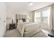 Well-lit bedroom featuring plush carpeting, natural light, and neutral decor at 802 Milo Bay St, Loganville, GA 30052