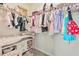 Spacious walk-in closet with organized storage solutions and colorful clothing at 802 Milo Bay St, Loganville, GA 30052