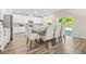 Well-lit dining area with modern lighting fixture and an open flow to the kitchen and outdoor space at 802 Milo Bay St, Loganville, GA 30052