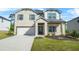 Charming two-story home featuring a brick facade, well-manicured lawn, and an attached two-car garage at 802 Milo Bay St, Loganville, GA 30052