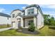 Eye-level of a modern two-story house with brick and gray siding, a two-car garage, and a landscaped yard at 802 Milo Bay St, Loganville, GA 30052