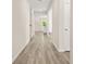 Inviting hallway featuring wood-look floors and neutral wall tones, leading into a bright and airy living space at 802 Milo Bay St, Loganville, GA 30052