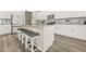 Modern kitchen island with gray upholstered stools and ample storage, great for Gathering and entertaining at 802 Milo Bay St, Loganville, GA 30052
