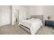 Comfortable main bedroom with plush carpeting, a large bed with a tufted headboard, and two doors at 802 Milo Bay St, Loganville, GA 30052