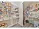 Spacious walk-in pantry with organized shelving offering ample storage for groceries and kitchen essentials at 802 Milo Bay St, Loganville, GA 30052