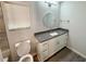 A modern bathroom featuring a granite countertop, white vanity, and a round mirror at 1351 E Atlanta E Rd, Stockbridge, GA 30281