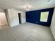 A bright bedroom featuring a blue accent wall, modern lighting, and ample space at 1351 E Atlanta E Rd, Stockbridge, GA 30281