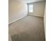 Neutral carpeted bedroom with window at 1351 E Atlanta E Rd, Stockbridge, GA 30281