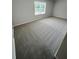 Bright bedroom with neutral carpeting and a large window overlooking the neighborhood at 1351 E Atlanta E Rd, Stockbridge, GA 30281