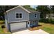 Two-story home with mixed siding, an attached garage, and a well-kept lawn showcasing its curb appeal at 1351 E Atlanta E Rd, Stockbridge, GA 30281