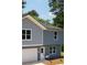 Charming two-story home with mixed siding, an attached garage, and a well-lit entrance at 1351 E Atlanta E Rd, Stockbridge, GA 30281