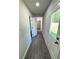Hallway with wood-look flooring leading to a door with a view of the yard at 1351 E Atlanta E Rd, Stockbridge, GA 30281
