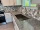 Kitchen features modern sink, granite countertop, stainless steel faucet and mosaic backsplash at 1351 E Atlanta E Rd, Stockbridge, GA 30281