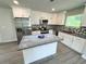 Kitchen with granite island, stainless appliances, custom backsplash, and pendant lighting at 1351 E Atlanta E Rd, Stockbridge, GA 30281