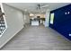 Open-concept living space with hardwood floors, modern kitchen, and a stylish navy blue accent wall at 1351 E Atlanta E Rd, Stockbridge, GA 30281