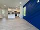 Open floor plan featuring luxury vinyl plank flooring, modern kitchen and designer blue accent wall at 1351 E Atlanta E Rd, Stockbridge, GA 30281