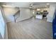 Open-concept living space features light wood flooring, a ceiling fan, and staircase leading upstairs at 1351 E Atlanta E Rd, Stockbridge, GA 30281