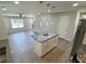 Open concept kitchen with granite island and stainless appliances leading to a living area at 1351 E Atlanta E Rd, Stockbridge, GA 30281