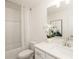 Clean and bright bathroom featuring vanity, framed mirror, white commode and shower/tub combination at 2680 Ne Almand Lane Ne, Conyers, GA 30013