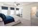 Bright main bedroom featuring large windows, tray ceilings, ceiling fan and en suite bathroom at 2680 Ne Almand Lane Ne, Conyers, GA 30013