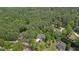Scenic aerial view of a residential property nestled among lush greenery and mature trees at 5071 Woodmont Dr, Villa Rica, GA 30180