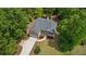 Aerial view of house and driveway, surrounded by lush trees at 5071 Woodmont Dr, Villa Rica, GA 30180