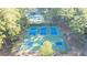 Aerial view of sports courts including tennis, pickleball, and basketball, nestled in a wooded community at 5071 Woodmont Dr, Villa Rica, GA 30180