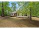 Backyard view of house with a screened porch and a back deck at 5071 Woodmont Dr, Villa Rica, GA 30180