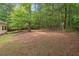 Lush backyard, bordered by dense trees for privacy at 5071 Woodmont Dr, Villa Rica, GA 30180