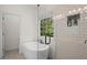 Modern bathroom with a standalone tub, glass-enclosed shower, and stylish tiling at 5071 Woodmont Dr, Villa Rica, GA 30180