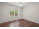 Bright bedroom features hardwood floors, neutral walls, and a window with natural light at 5071 Woodmont Dr, Villa Rica, GA 30180