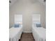 Bedroom featuring two twin beds with matching striped pillows, hardwood floors, and vaulted ceiling at 5071 Woodmont Dr, Villa Rica, GA 30180
