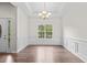 Bright dining room features hardwood floors, wainscoting and a decorative chandelier at 5071 Woodmont Dr, Villa Rica, GA 30180